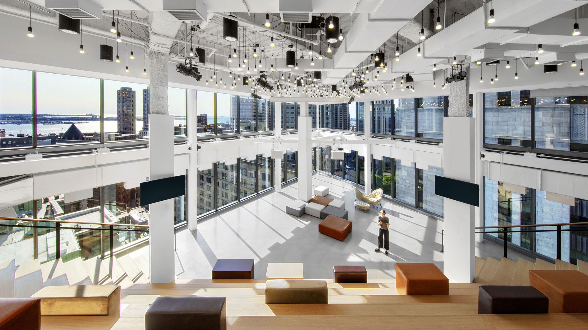 Grand two-story amphitheatre of reception at Publicis Groupe with views of Boston Harbor