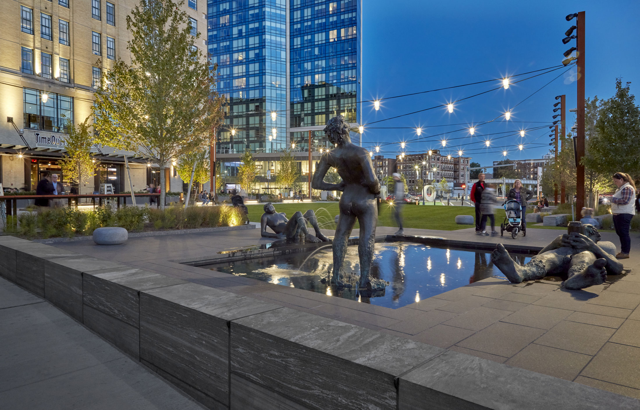 The project's one-acre community park—"The Green"—is a transformed parking lot. A green oasis that welcomes the public, artist Nicole Eisenman's playful outdoor sculpture, "Sketch for a Fountain," anchors a corner, while Time Out Market's outdoor terrace enlivens the building edge.