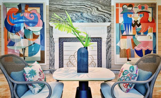 Breakfast area in the gallery of White Elephant Palm Beach with artwork by Bernhard Buhmann flanking a historic fireplace