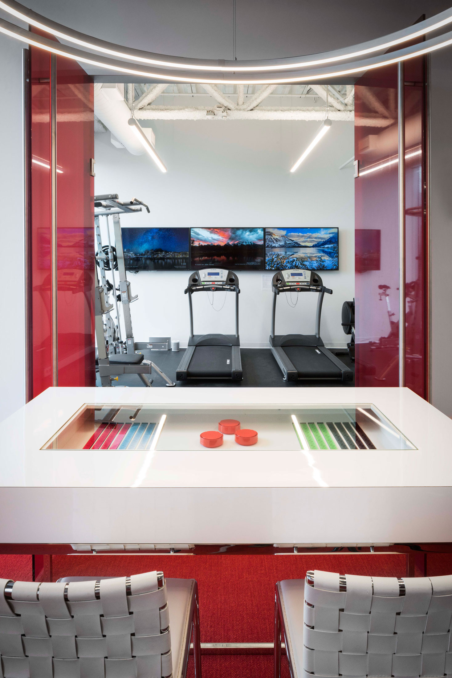Looking over a device display case into an exercise room
